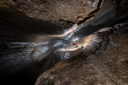 A caver abseiling The Monster in Torca del Regalon, viewed from the top of the shaft.